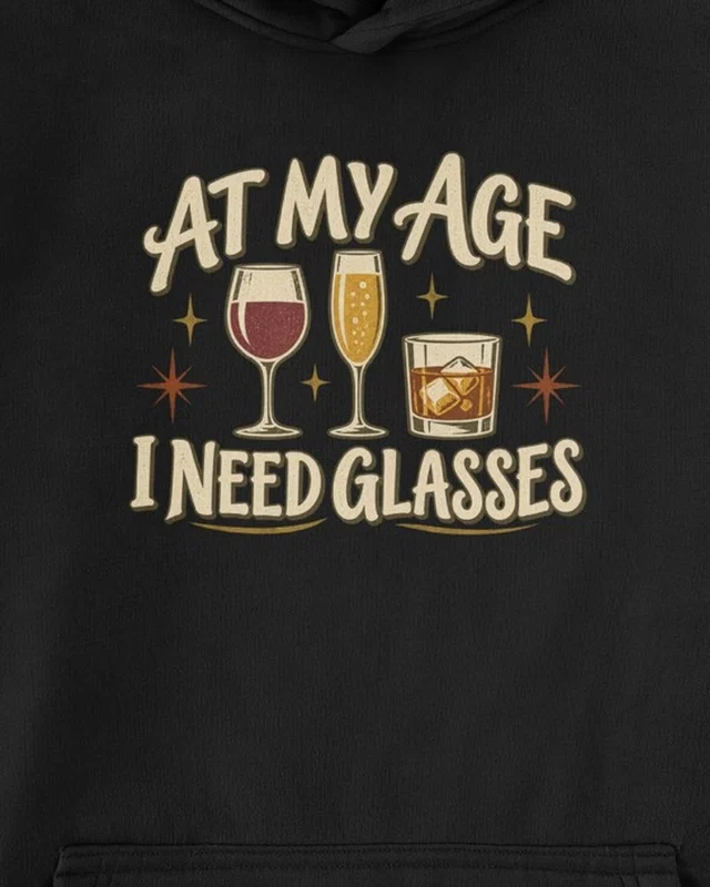 At My Age I Need Glasses Graphic Hoodie in Black — cropped design detail